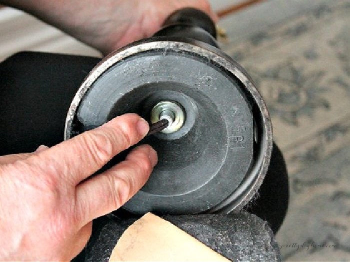 Shwoing the inside of an electric lamp base, to illustrate  removal of the wiring, while repurposing the old lamp into a solar light for outdoors.