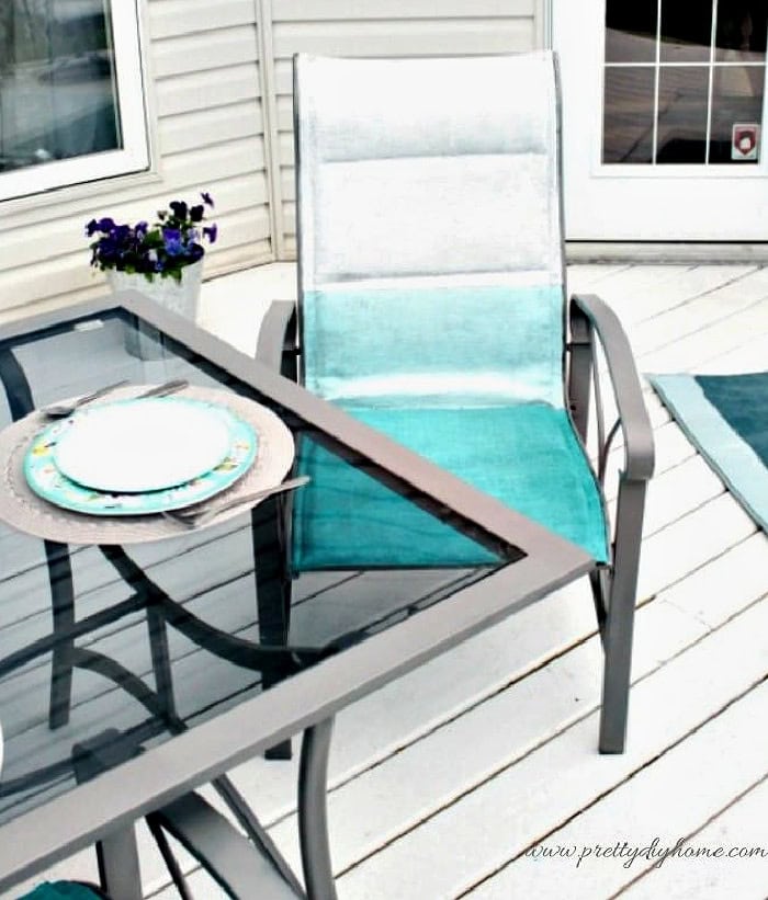This close-up shows the painted metal patio chair frame after applying spray paint.
