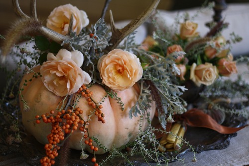 Elegant fall decorating idea, floral arrangement with antlers and pumpkin