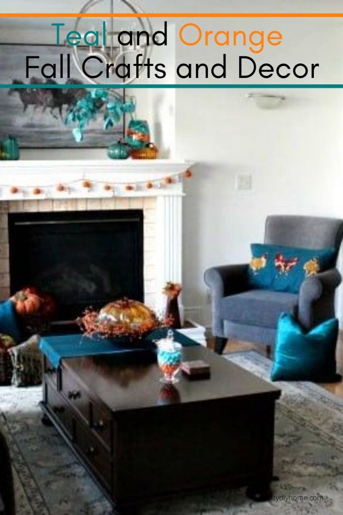 A livingroom decorated for Fall in orange and teal DIY home decor and easy Fall crafts, such as cushions table runners, lights and flower arrangements.