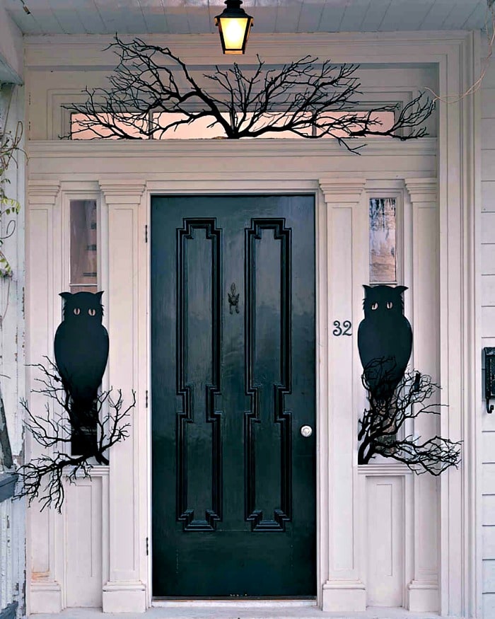 Elegant appearing Halloween front porch with Owls and a black door. DIY Halloween front porch ideas, Halloween porch displays, DIY Halloween yard decorations, DIY Halloween front porch ideas, DIY Halloween front door decorations, 