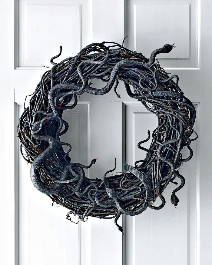 A DY snake wreath for Halloween. DIY Halloween front porch ideas, Halloween porch displays, DIY Halloween yard decorations, DIY Halloween front porch ideas, DIY Halloween front door decorations,