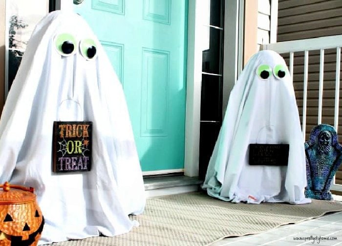 Porch halloween decor, two ghosts made out of sheets.