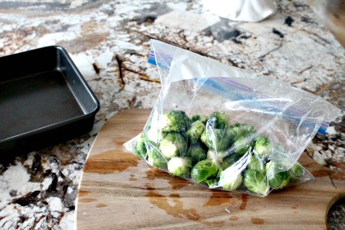 Coating brussel sprouts with oil for making roasted brussel sprouts