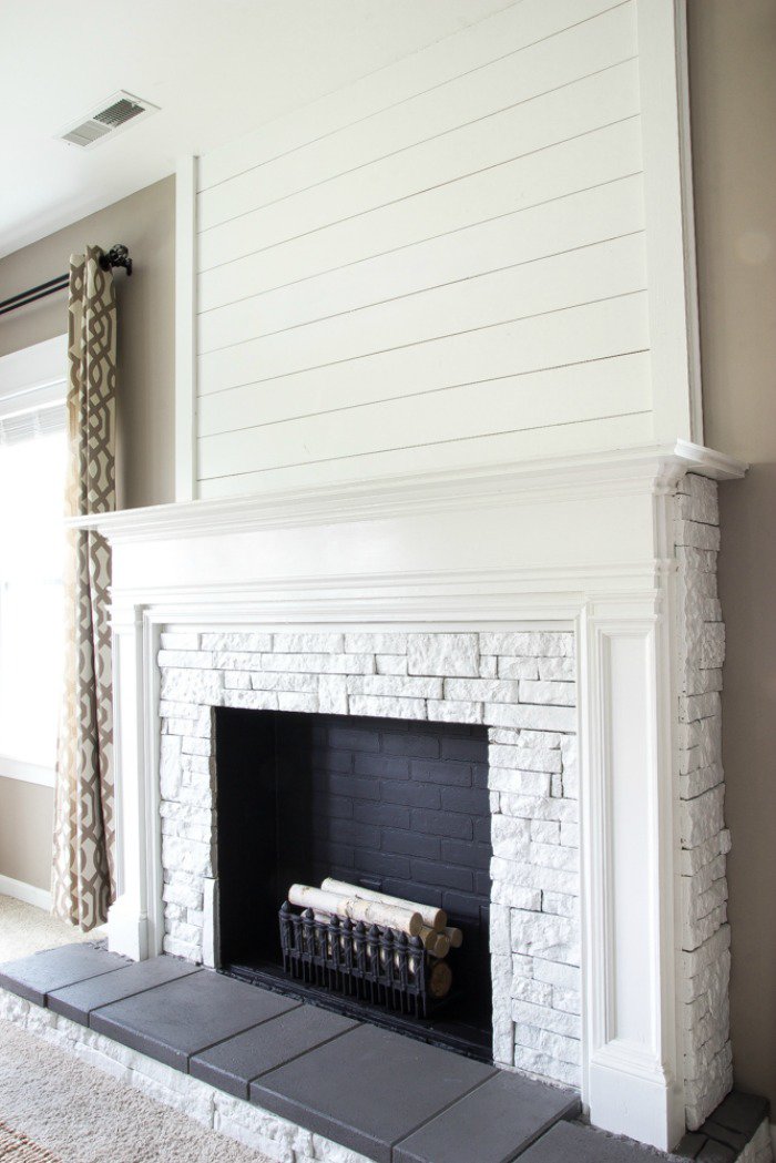 DIY Faux fireplace in white with a mantel. Very pretty for fall decorating or Christmas decor.