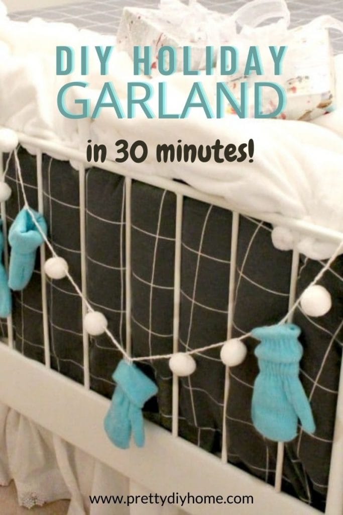 A blue and white mitten garland hanging on the end of a bed for Christmas decorating.