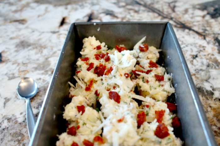 A pan full of ready to bake potato appetizers. An easy make ahead party food appetizer recipe.