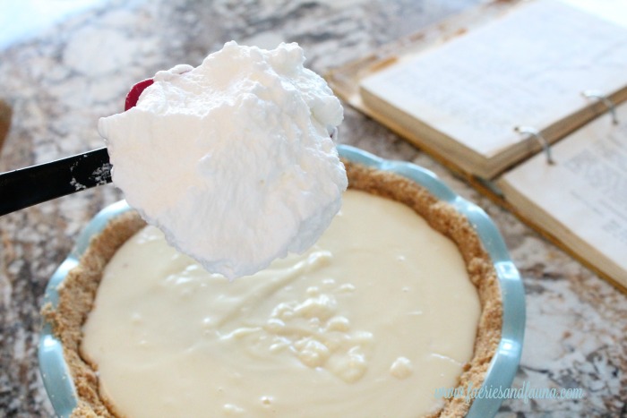 Fluffy white meringue being placed onto the filling of a flapper pie. flapper pie, flapper pie recipe, vintage pie recipe, vintage recipes,