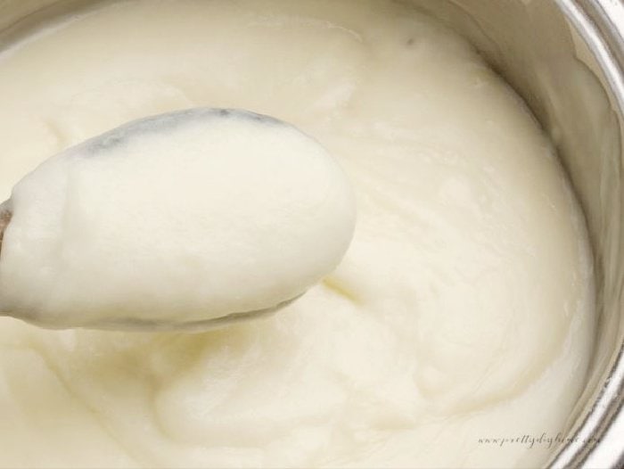 A double boiler filled with a creamy thick vanilla custard for making flapper pie.