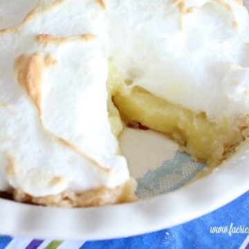 Lemon Meringue pie with a cut serving.