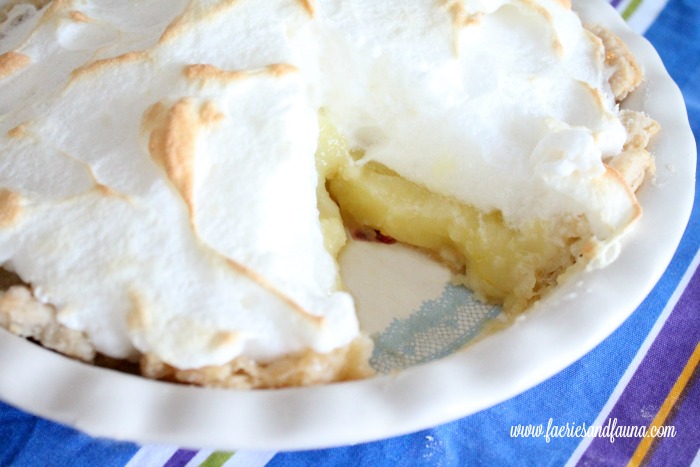 Lemon Meringue pie with a cut serving.