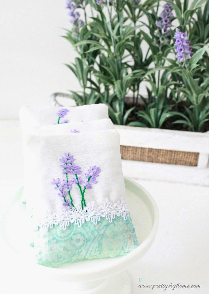 Close-up of a lavender sachet with a lavender plant in the background.
