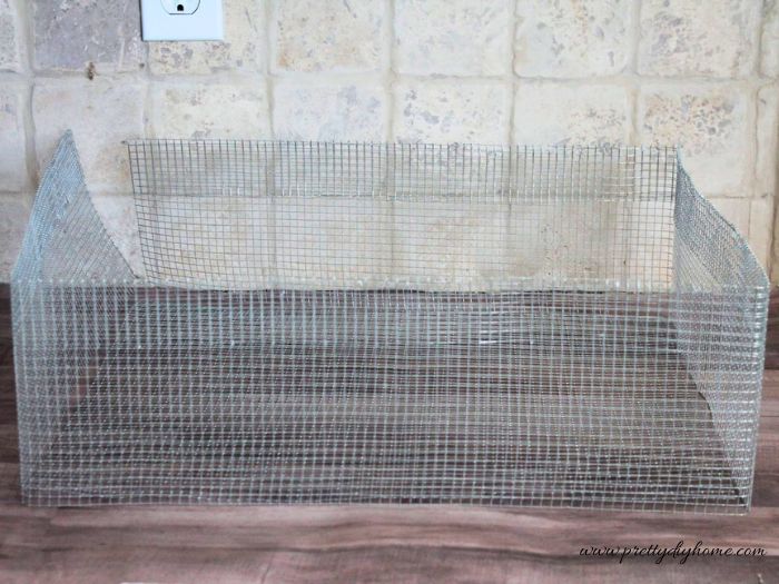 The wire mesh is folded into shape to form a basket with the corners defined and one open seam.