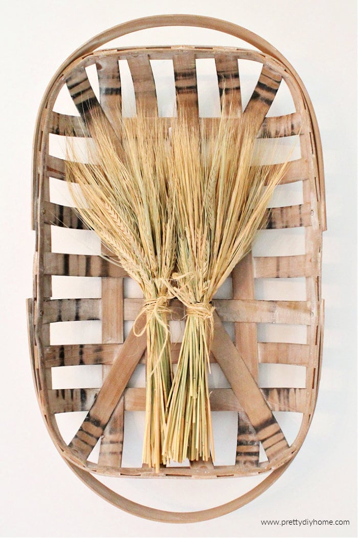 Fall tobacco basket decorated with dried wheat in pretty golden bundles.