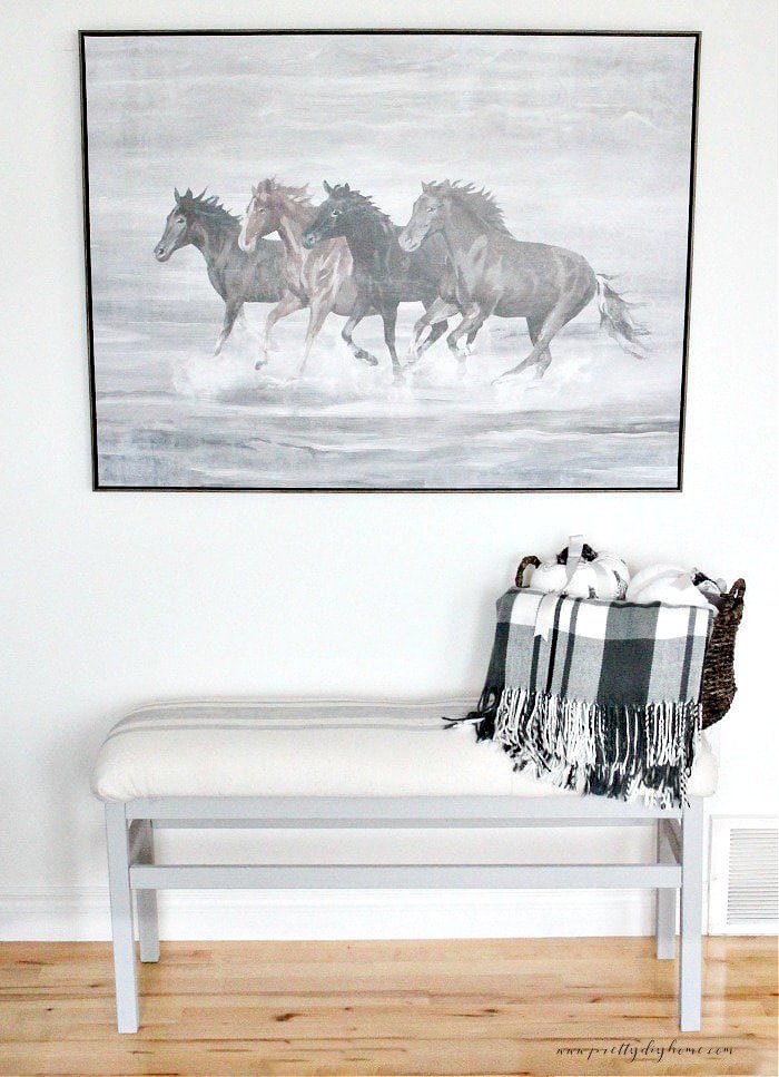 A grey and white DIY bench upholstery project in white and gray grainsack stripes.  An easy DIY bench upholstery project.