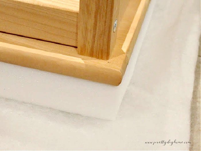 The layers needed to cover a wood bench with a soft cushion.  There is a batting layer, a two inch layer of thick high density cushion foam, and then the wood top.