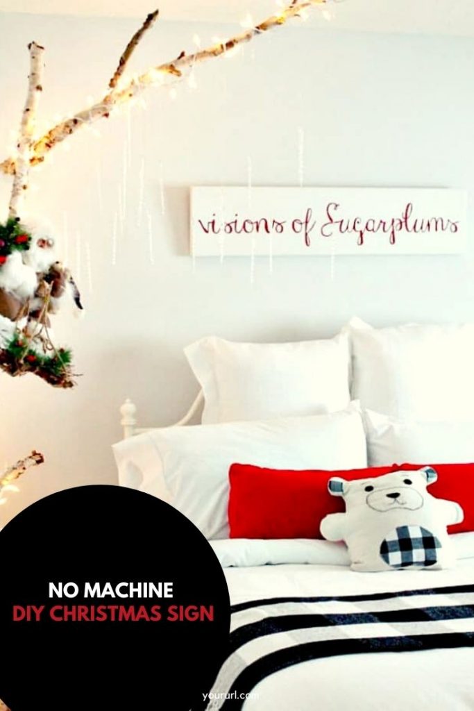 White and red sign hanging over a bed in a child's bedroom.