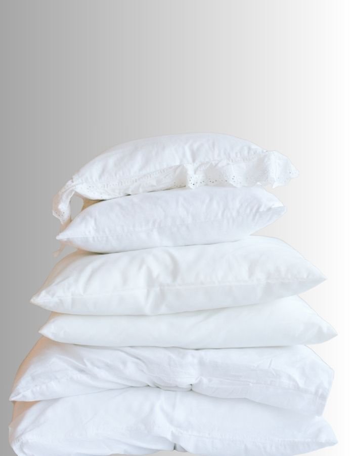 A stack of different standard sized pillow inserts. There are six diy pillow inserts in the image.