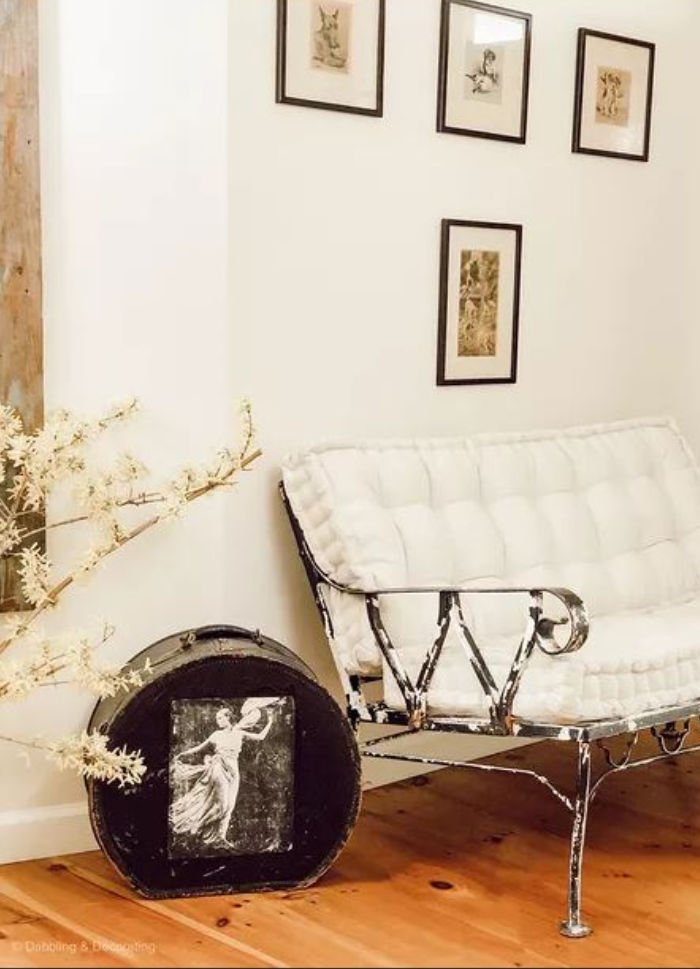 Black and white home decor with a DIY wrought iron chair makeover and black vintage suitcase.