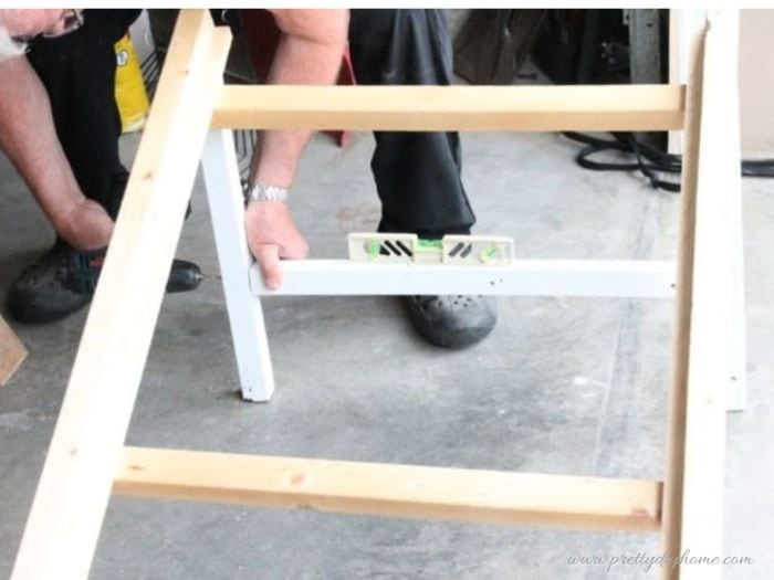 Adding braces between the upright supports on a DIY dog ramp or pet ramp frame.