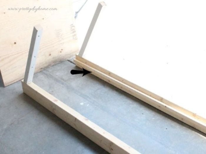 Two side rails with upright supports positioned correctly for assembling a DIY dog ramp frame.