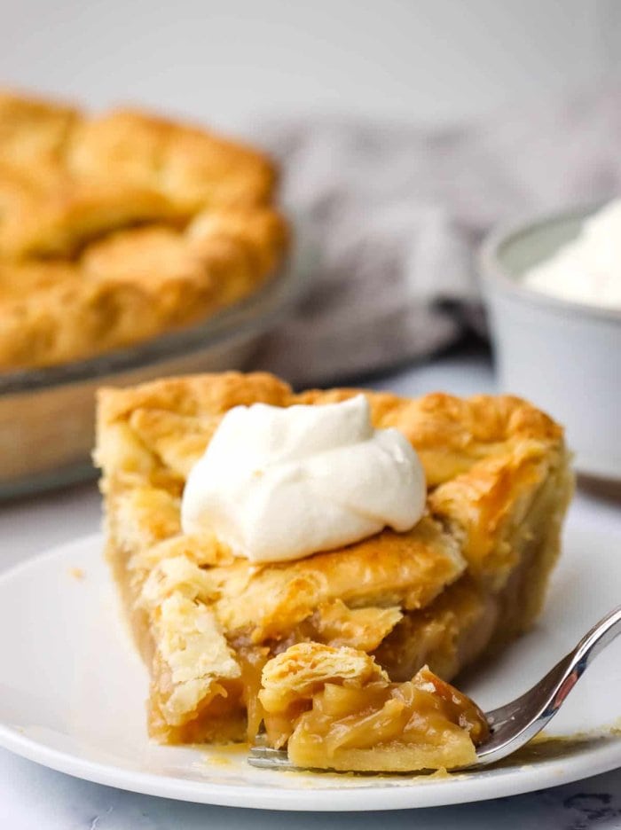 A traditional quebec sugar pie with whipped cream topping.