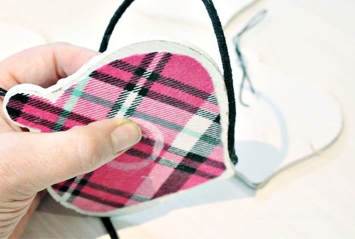 A handmade Christmas ornament with flannel plaid.