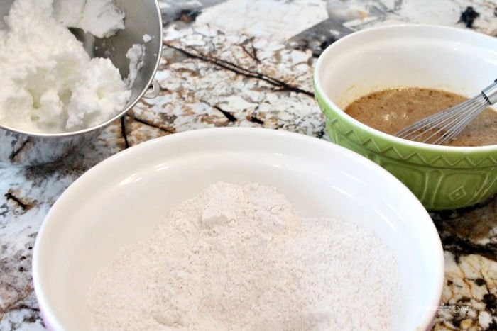 Egg whites, flour and molasses ingredients for a gingerbread waffle recipe.