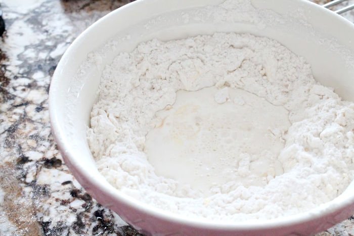 Making a well in flour for making homemade Cranberry Scone recipe.