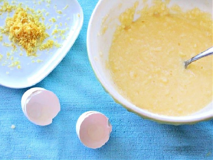 Making the batter for lemon bars, with a plate of shredded lemon peel and the shell of an egg.