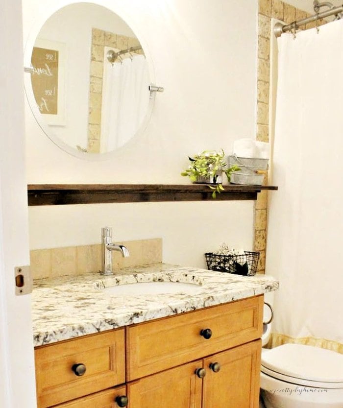 A bathroom decorated in farmhouse style with a new DIY backsplash tiling.