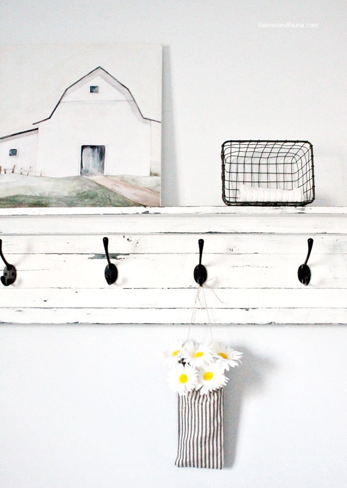 A handmade fabric pouch craft hanging on a shelf for farmhouse decor.