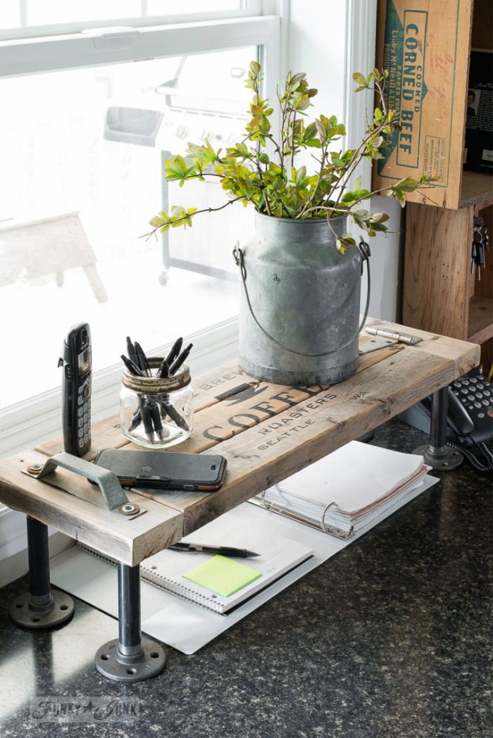 DIY wood and metal industrial farmhouse shelf for the office. Decorated with galvanized decor, a plant and office supplies.