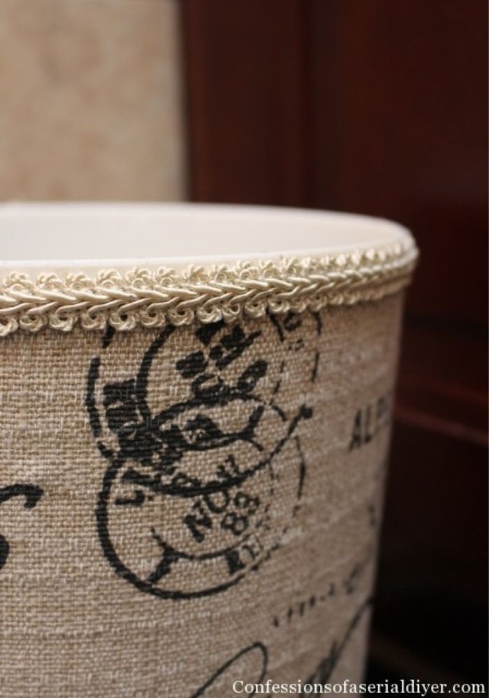 DIY monogrammed waste basket hack in cream and place with a pretty corded top.