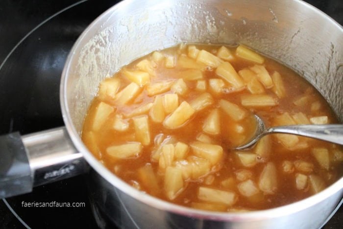 Cooking pineapple for making an upside down pineapple cake in a baked donut recipe.