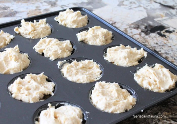 a baked donut pan being filled with pineapple glaze and homemade sour cream baked donut batter..