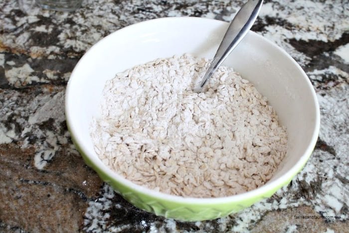 Mixing dry ingredients for a from scratch oatmeal raisin cookie recipe.