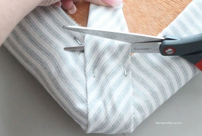 How to fold corners on a DIY no sew cushion cover project.