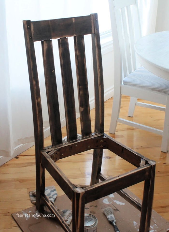 A sanded chair being refinished.