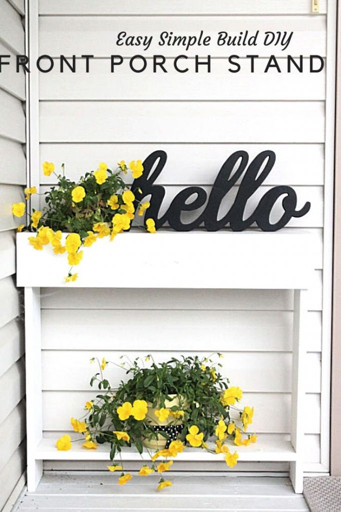 A small DIY Front Porch Table pained white with yellow pansies and the word hello.