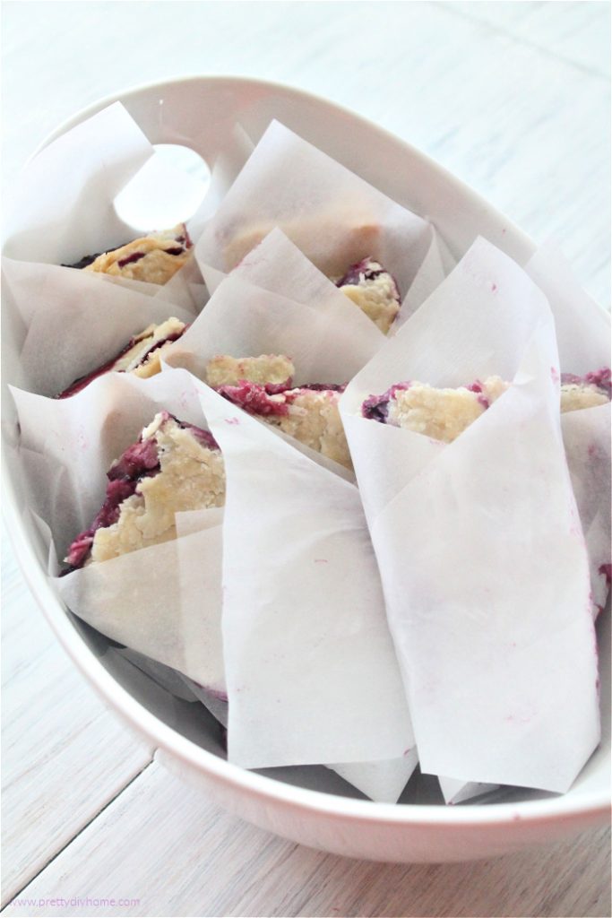 From scratch bumbleberry slab pie cut into finger size and wrapped in parchment for serving.