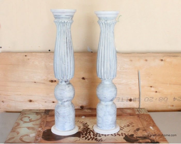 Two built wood DIY candle holders primed with Binz primer in white.