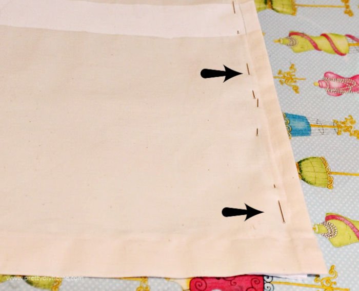 A picture showing the pin placement for sewing the edge of a muslin to the edge of a inexpensive shower curtain.