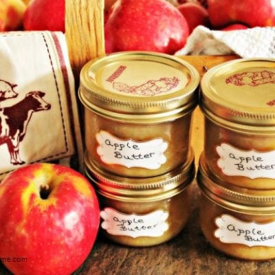 Homemade apple butter canned and labelled into canning jars.