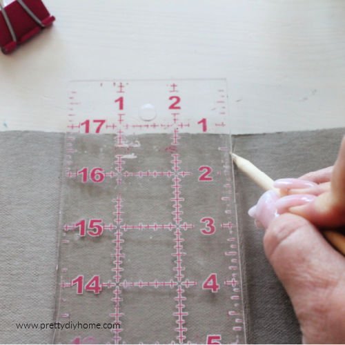 Using a pointed stick to crease the inside of a fold using washable paper.