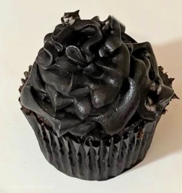 Dark black icing on a cupcake