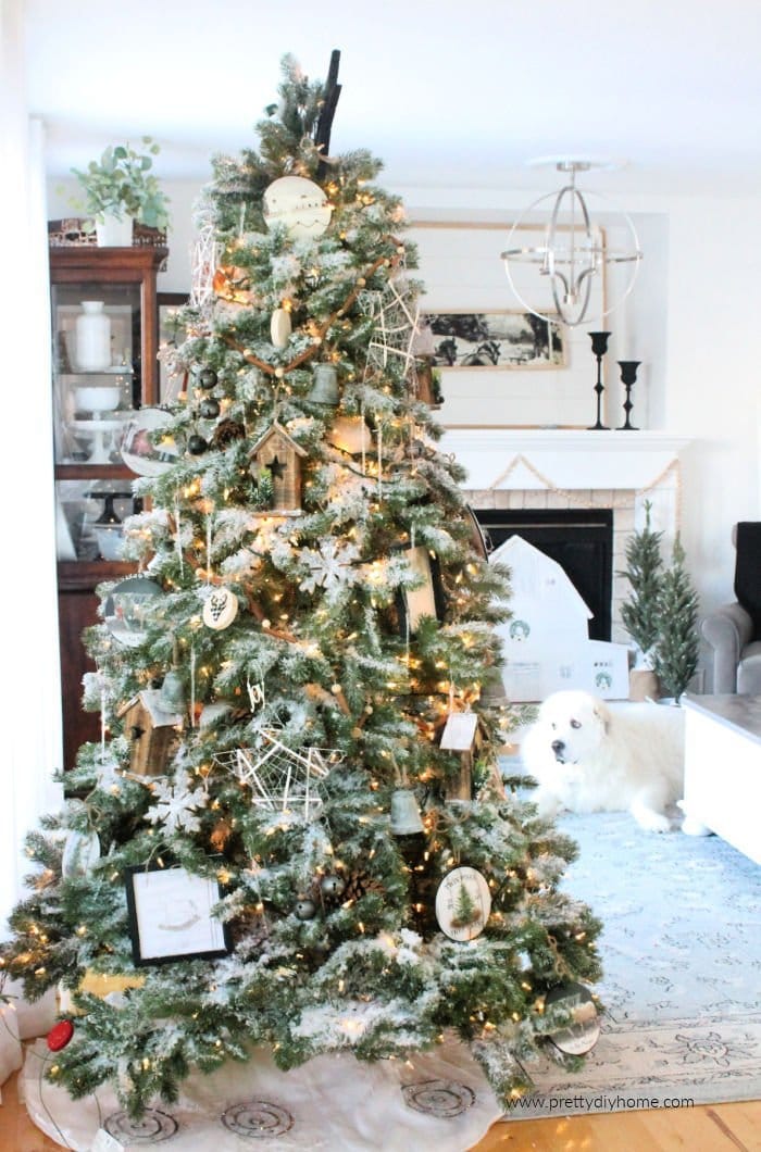 Large Christmas tree decorated in neutral colours in a farmhouse Christmas living room.