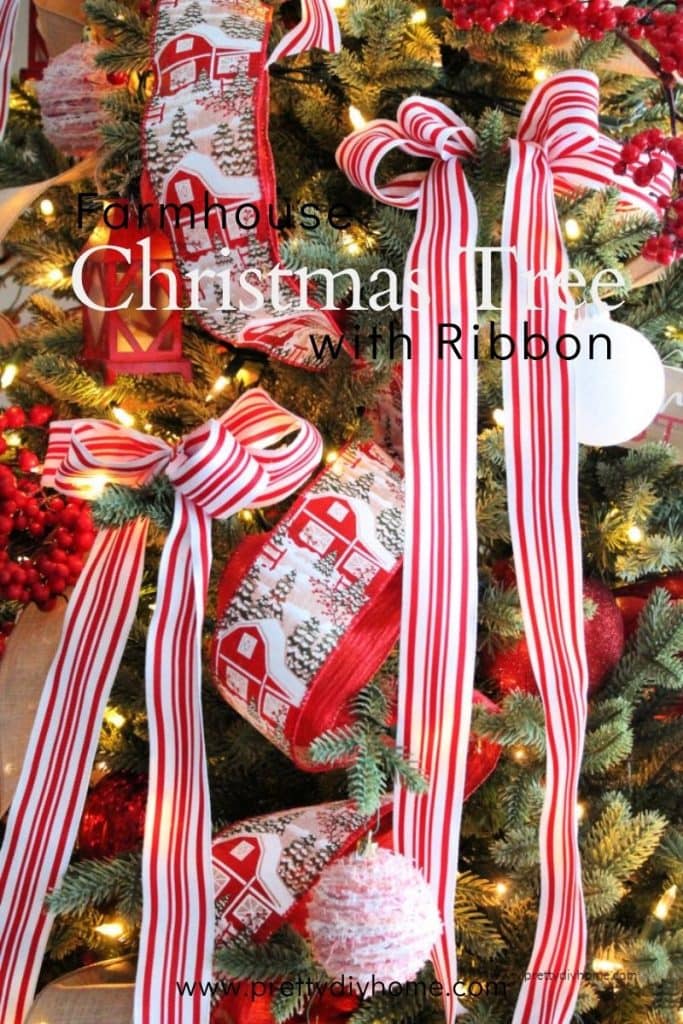 A farmhouse Christmas tree decorated in red and white with lots of ribbon and DIY ornament.