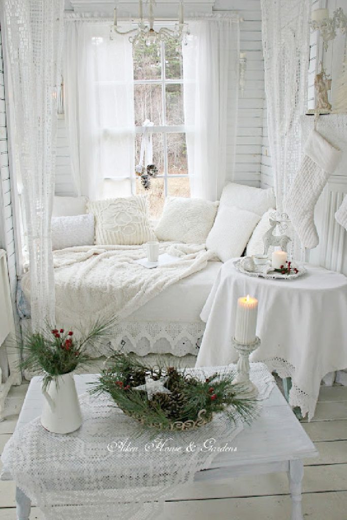 Cozy cottage living room in all white Christmas decor with a shabby chic feel.