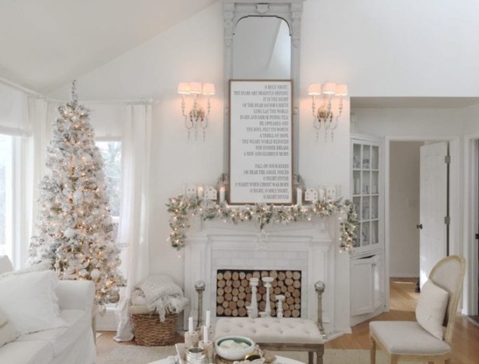 Bright white Living room with white Christmas sign over a white Christmas mantel and White Christmas tree